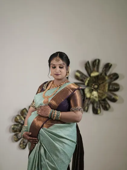 Our client Ranjitha looking beautiful and serene during her baby shower photoshoot in a custom blouse and saree.