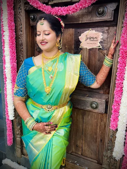 A gorgeous bride in a sea-green silk saree. The makeup is kept fresh and radiant to complement the unique saree color, creating a memorable look for her wedding day.