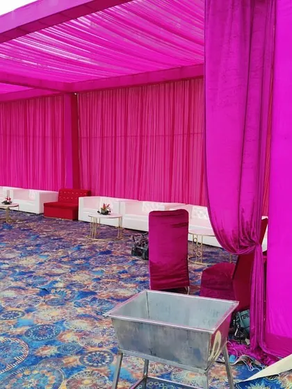 Another example of a lounge corner within a wedding tent, providing a comfortable space for guests to relax away from the main dining area.