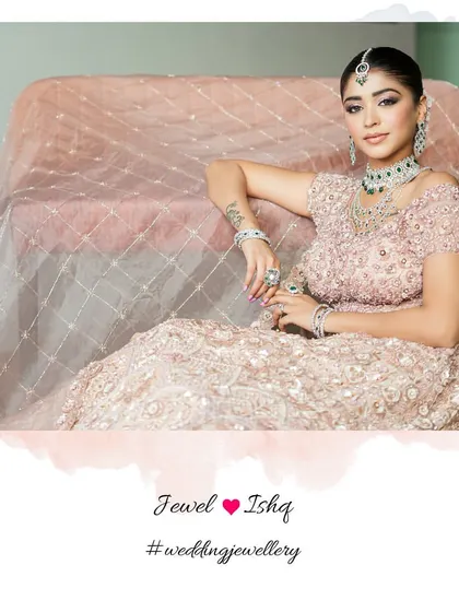 A moment of quiet elegance. The bride looks absolutely regal in her pink lehenga and our full emerald and diamond jewellery suite.