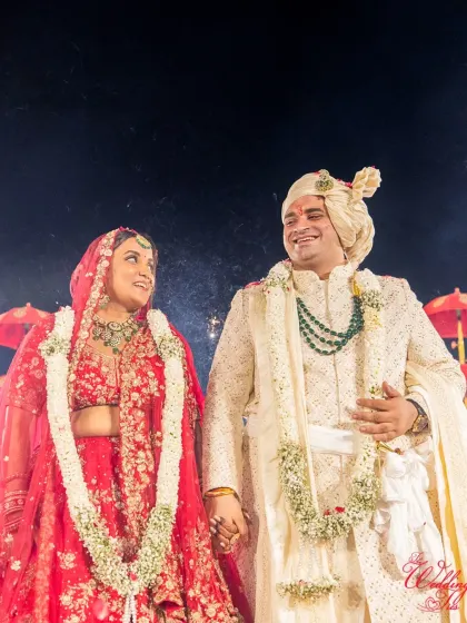 A beautiful candid moment between the bride and groom, sharing a smile during their wedding ceremony.