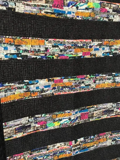 A detail shot of the "Graffiti" quilt, showing the interesting fabric and the dense quilting.