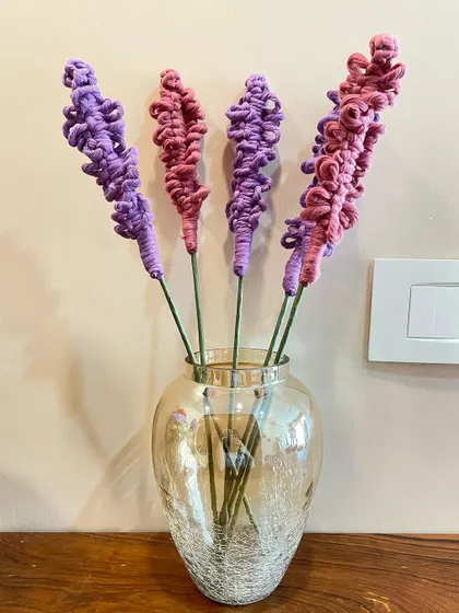 These macrame lavender flower sticks are perfect for adding a touch of color to a vase. The textured knots mimic the look of real lavender sprigs.