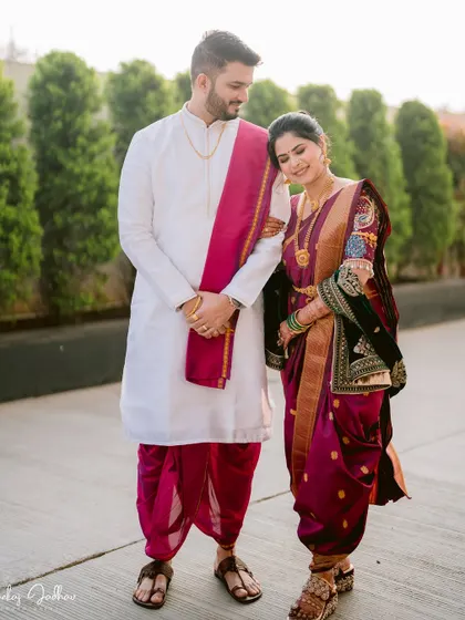 A classic full-length portrait of Karan and Shruti in their traditional Peshwai wedding attire.