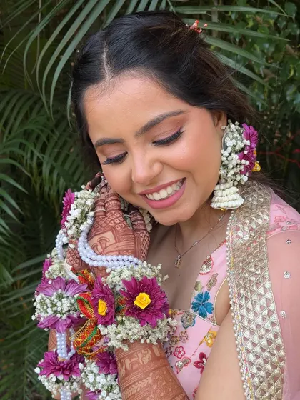 A beautiful Haldi ceremony look. The makeup is kept fresh and minimal, with floral jewelry completing the look.