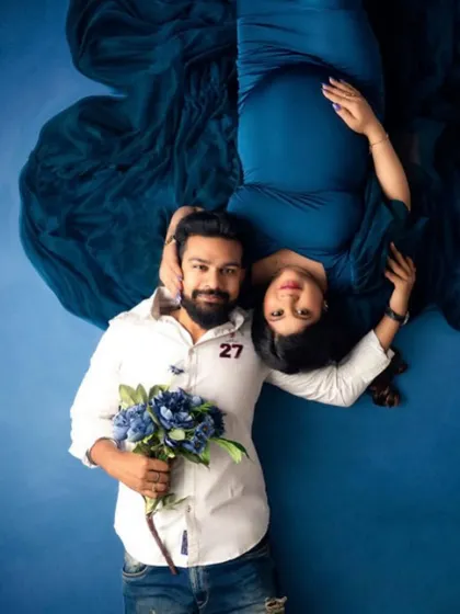 A creative top-down shot celebrating their love story. The flowers and coordinated colors add a beautiful touch to this unique couple's portrait.