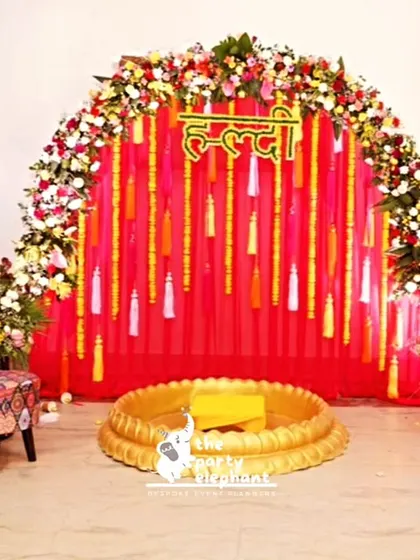 For the Haldi ceremony, I created a similar setup with a bright floral arch and a special brass 'urli' in the center for the traditional rituals, ensuring the decor was both beautiful and functional.
