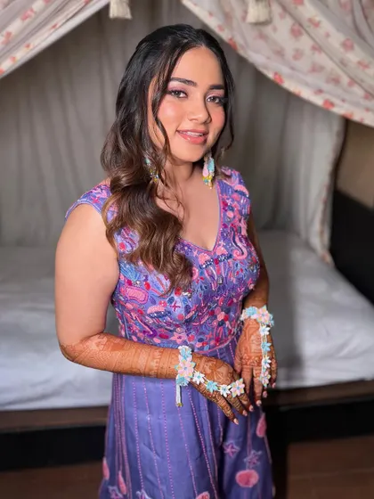 A magical carnival look for my sunshine bride. We used a pop of purple, rhinestones, and a cute starfish in her hair for a fun, mermaid vibe.