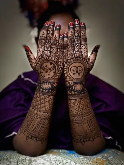 A creative design with a clock showing a special time on one palm and the couple's initials, 'SR', on the other.