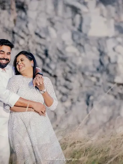 Another candid moment of laughter and affection from the same outdoor maternity session, showing the couple's genuine happiness.