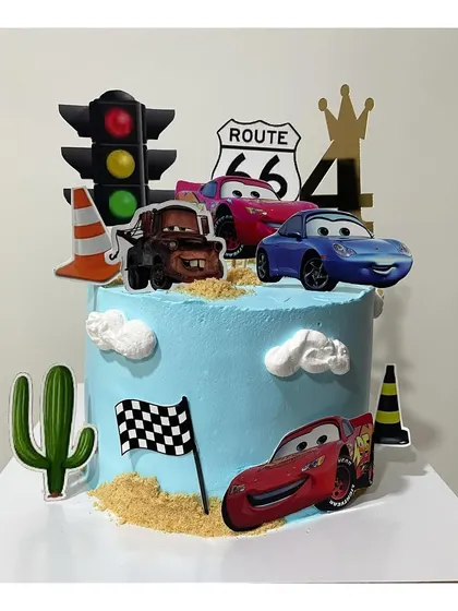 Another take on the "Cars" theme cake, this one featuring more toppers like traffic lights and cacti for a full desert race scene.