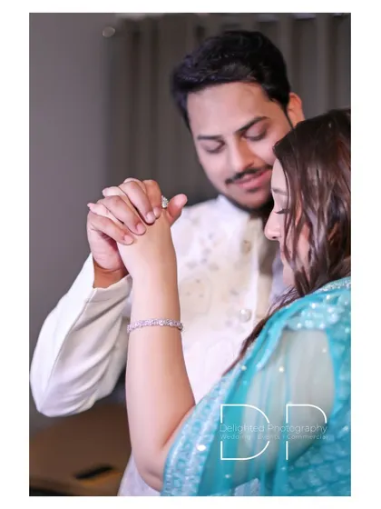 A close-up shot focusing on the couple's hands as they share a slow dance, a simple yet intimate moment from their engagement.