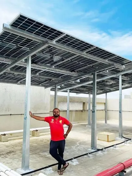 A resident of one of the newly solarised Bangalore societies leans against the sturdy WindPro mount of his new system.