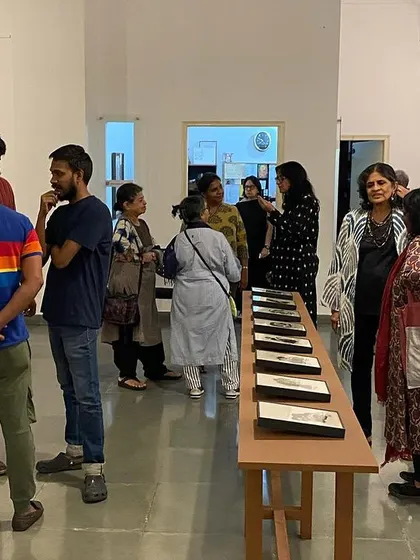 Visitors at the opening night of 'Quieter than Silence', interacting with each other and the art.