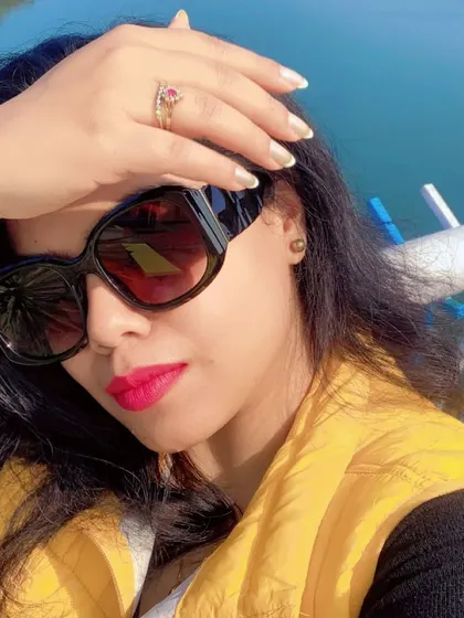 A close-up selfie from a winter trip, with a bright pink lip and oversized sunglasses.