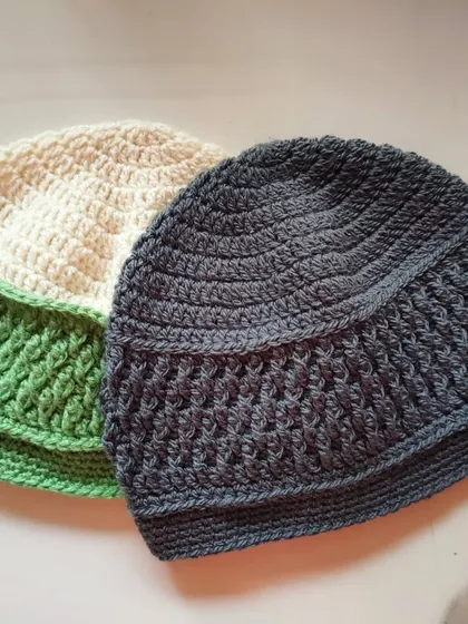 A pair of Sheldon beanies in green and cream, and a solid charcoal grey. The Alpine stitch provides wonderful texture and warmth, making it a very practical winter hat.