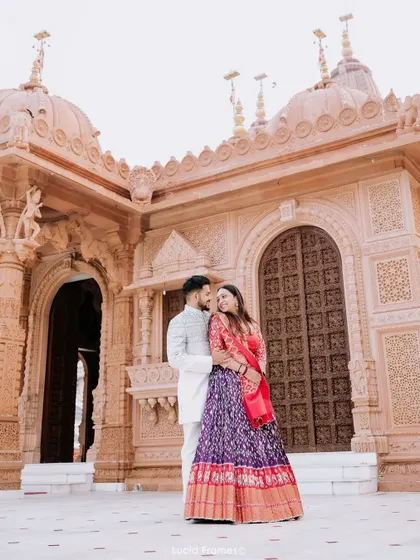 A sweet and simple portrait of the couple in front of the temple, a timeless memory of their pre-wedding shoot.