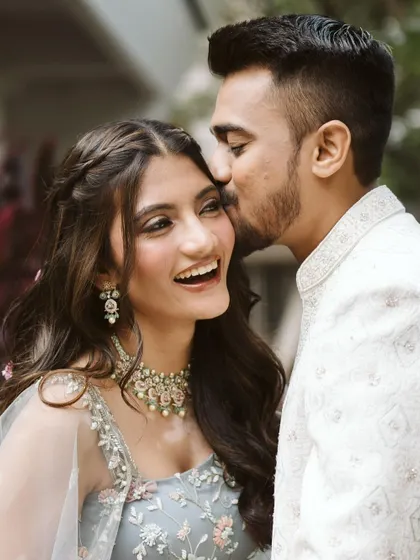A sweet moment between the happy couple. Aayushi's makeup is soft and romantic, perfect for these intimate photos.