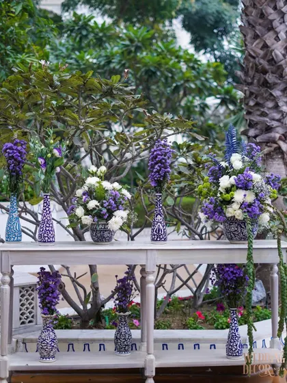 A console table displaying a variety of floral arrangements in blue and white patterned vases. This created a beautiful focal point in one of the garden areas.