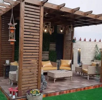 I designed this outdoor living area to be a true extension of the home. The custom wooden pergola provides structure and shade, while the integrated seating and layered lighting create a warm, inviting atmosphere for relaxing or entertaining, day or night.