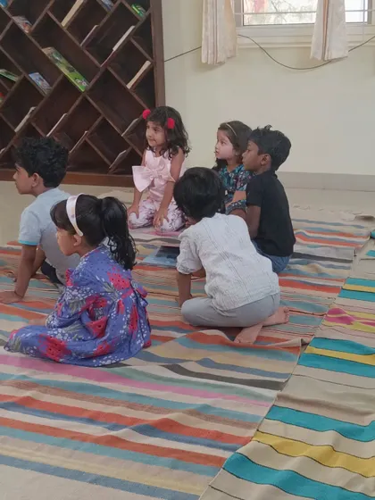 A duplicate shot capturing the children's attentive posture during the story.