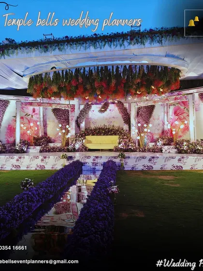 This is where elegance meets celebration. We designed this grand reception stage with a stunning overhead floral chandelier and a mirrored walkway lined with lush purple flowers, creating a luxurious and unforgettable ambiance for the couple and their guests.