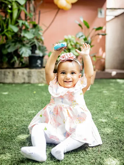 This little one is having a blast at her first birthday party in the garden. I love capturing the joy and excitement of these big celebrations.