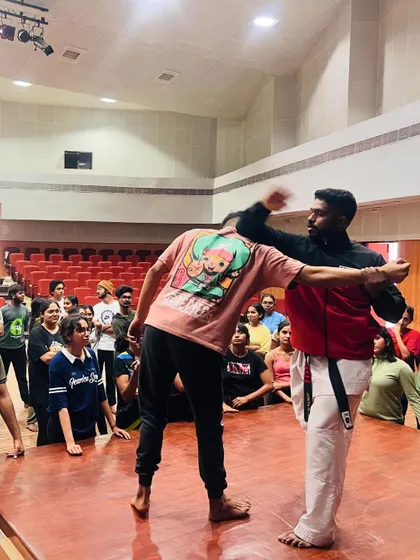 I show a student how to block a strike and create an opening for a counter-attack during a live demonstration.