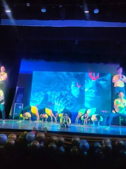 The beginning of the yoga performance, with students in a powerful warrior stance. The energy on stage was incredible, and it was a proud moment for all of us at Anubhuti Yog.