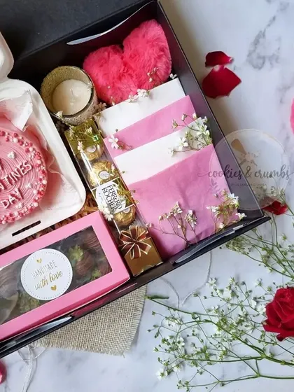 A complete Valentine's Day hamper in a box. It includes a bento cake, brownies, cookies, and other sweet treats, all in a romantic pink and red theme.