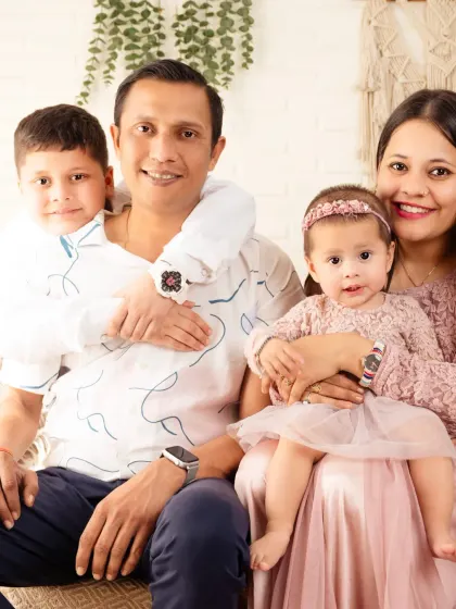 A warm family portrait with a son hugging his dad, showing the close bond between all family members.