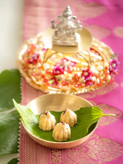A beautifully balanced shot of the Ganesh Chaturthi offerings, with soft, natural light. This image emphasizes the harmony and peace of the festive setup.