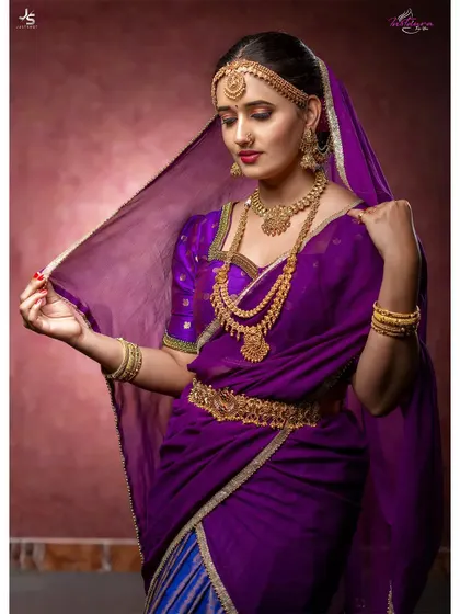 A graceful pose in the purple muhurtham saree, showing the sheer veil and traditional jewelry.