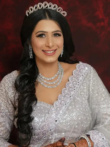 A beautiful portrait of an engagement bride wearing a tiara. Her makeup is elegant and classic, with a focus on clean lines and a radiant smile.