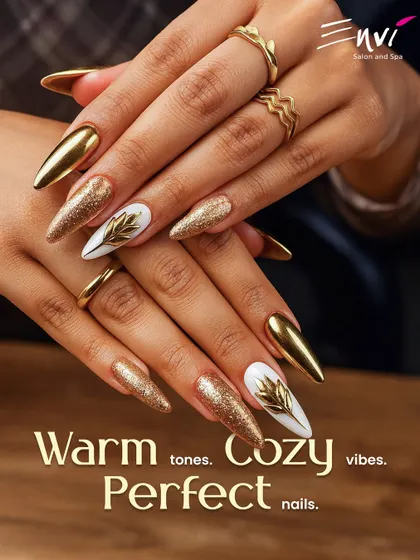 Make a bold statement with these stunning gold chrome and glitter nails. This design is perfect for festive occasions or for any bride wanting a touch of glamour, featuring sharp stiletto shapes and intricate leaf details.