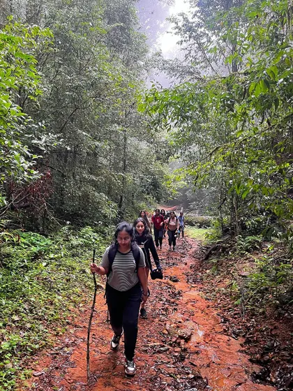 Our group navigating a muddy forest trail during the Kurinjal trek.