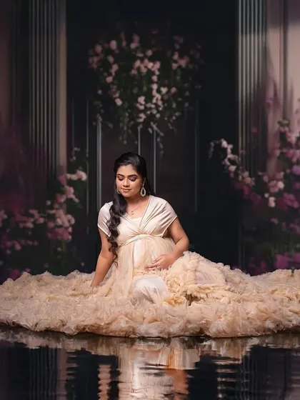 A serene and magical edit, placing the mom-to-be in a surreal, reflective water palace. This is for clients who want a portrait that is truly out of this world.