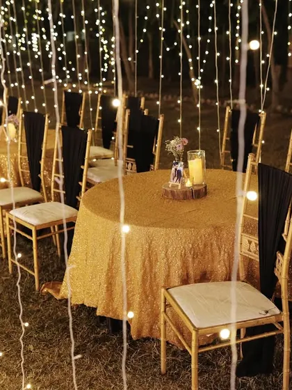 Intimate guest seating surrounded by a curtain of fairy lights, creating a cozy and magical dining experience.