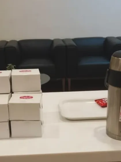 A setup for a corporate tea break, featuring our snack boxes and a large flask of hot chai. It's a simple and effective way to cater for meetings and small events.