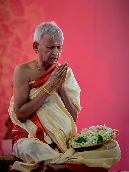 A senior priest offers prayers during the Rishi Homa, a ceremony to honor the ancient sages. The devotion and wisdom of our priests are central to the spiritual atmosphere of the ashram.