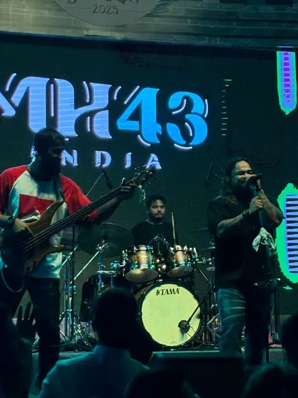 The trio in action. A classic shot of our bassist, drummer, and vocalist delivering a power-packed set for the Ernst & Young team.