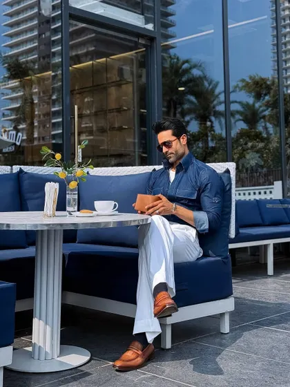 Our custom indigo denim shirt styled for a business brunch. Paired with white pleated trousers, it strikes the perfect balance between relaxed and refined.