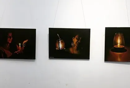 A clear shot of the three candle-light paintings.
