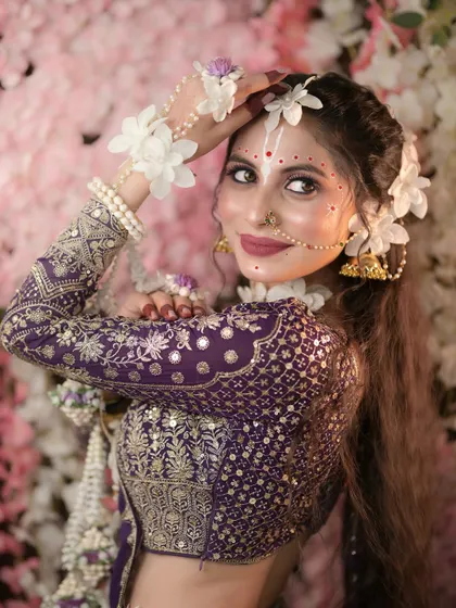 A lovely profile shot showing the hairstyle and makeup details.