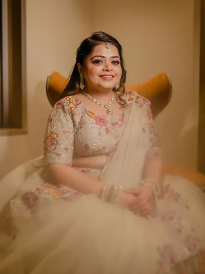A lovely seated portrait of the bride, her smile lighting up the frame. A perfect capture of her joy on her engagement day.