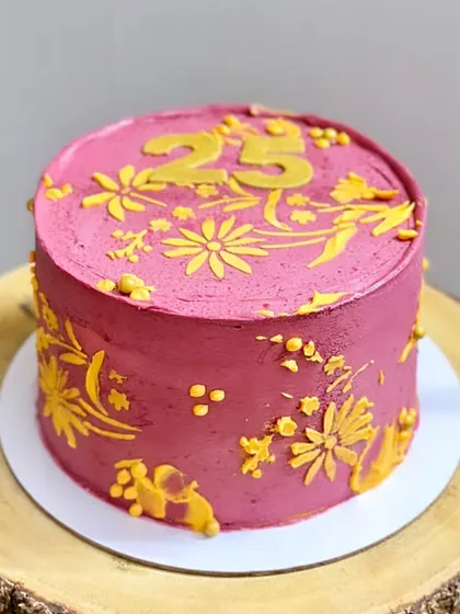 This cake was custom-designed to match the birthday girl's outfit. I used a vibrant pink buttercream and hand-piped yellow floral patterns to echo the design of her dress.