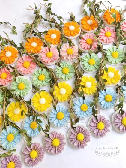 A rainbow of daisy soy wax sachets, part of a large bespoke Diwali gift box order for a client.