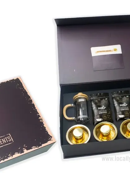 This premium coffee-themed gift box is perfect for any celebration. It includes a French press, coffee grounds, and elegant cups, all beautifully arranged in a "Best Compliments" box.