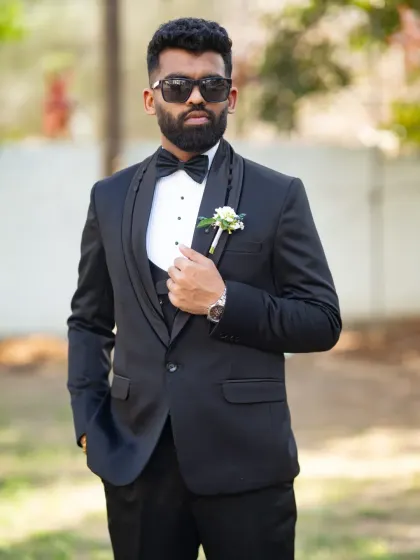 The groom looking sharp and cool in his sunglasses. This portrait captures a modern, confident vibe on the wedding day.