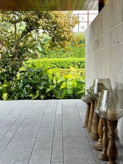 Another view under the entrance pergola, looking out into the lush garden.
